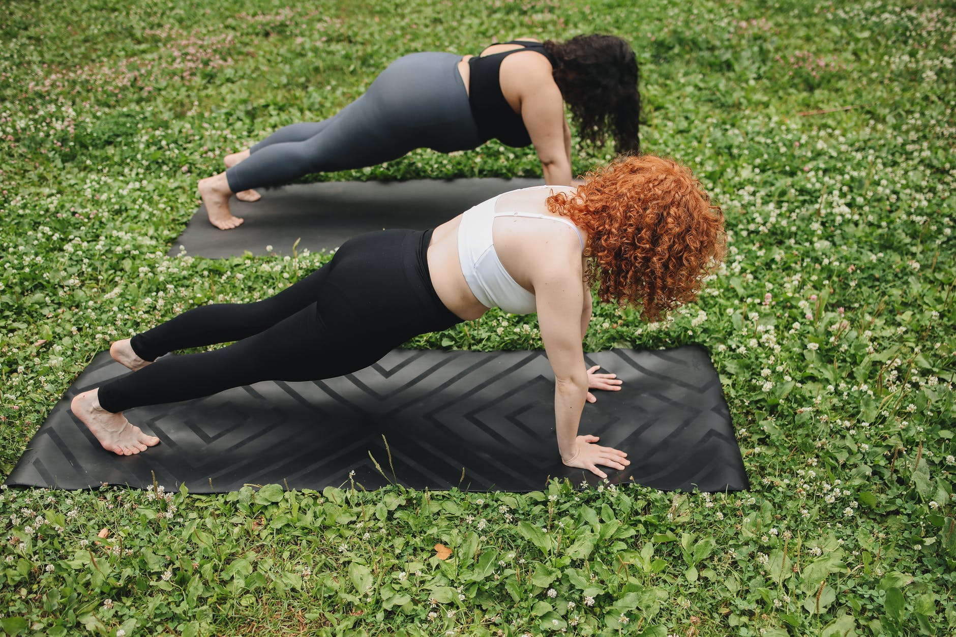 women in sports bra working out on yoga mat