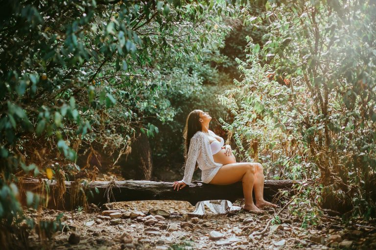 woman sitting on log